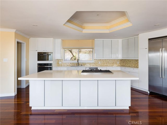 3311 Crownview Dr, Rancho Palos Verdes, CA 90275 - kitchen with appliances with stainless steel finishes, modern cabinets, ornamental molding, a kitchen island, and light countertops