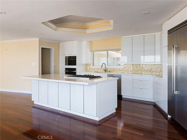 3311 Crownview Dr, Rancho Palos Verdes, CA 90275 - kitchen with appliances with stainless steel finishes, a kitchen island, dark wood finished floors, modern cabinets, and ornamental molding