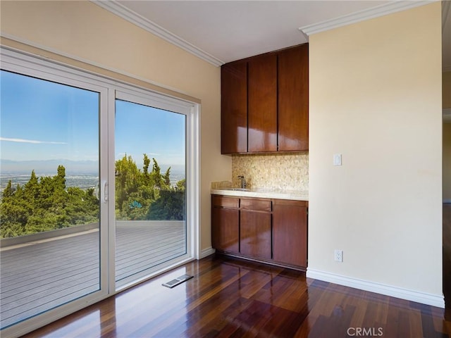 3311 Crownview Dr, Rancho Palos Verdes, CA 90275 - kitchen featuring dark wood-type flooring, backsplash, light countertops, and crown molding