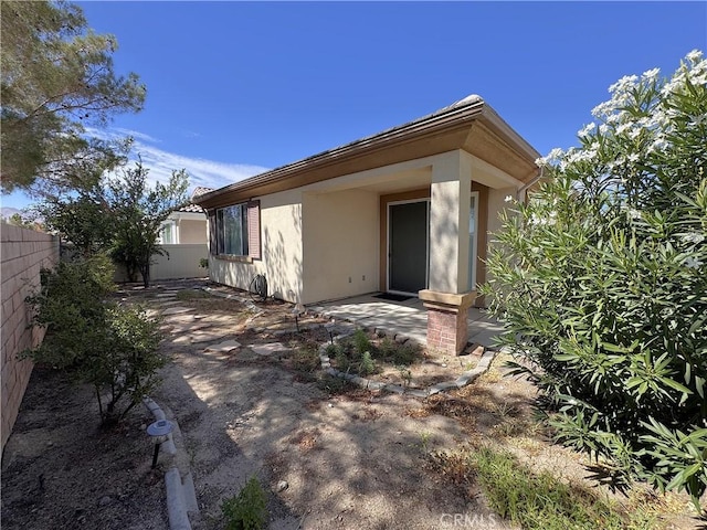 11115 Sun River Ct, Apple Valley, CA 92308 - back of house with stucco siding and a patio area