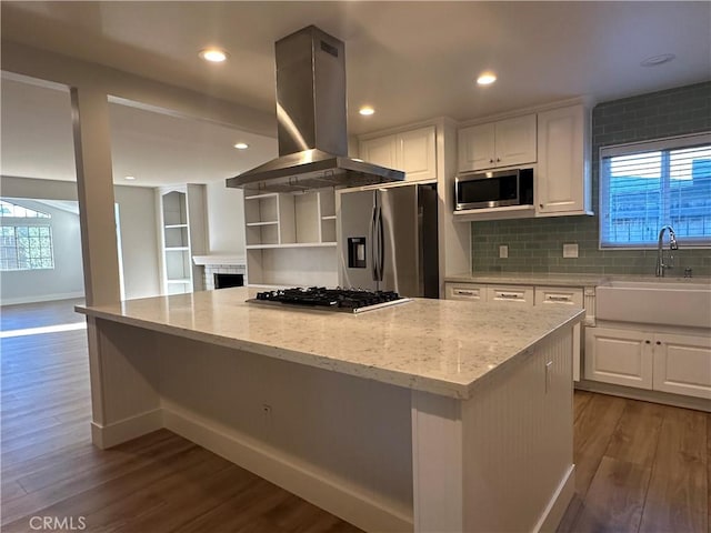 16415 Red Coach Ln, Whittier, CA 90604 - kitchen featuring island range hood, stainless steel appliances, wood finished floors, white cabinetry, and recessed lighting