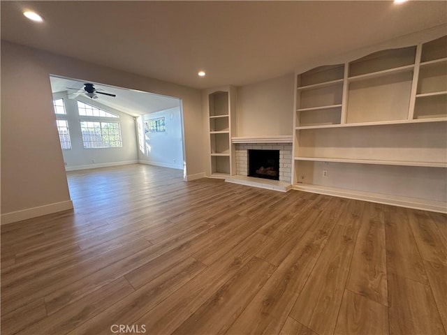 16415 Red Coach Ln, Whittier, CA 90604 - unfurnished living room with wood finished floors, ceiling fan, a fireplace, vaulted ceiling, and recessed lighting