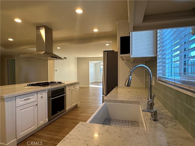 16415 Red Coach Ln, Whittier, CA 90604 - kitchen featuring stainless steel appliances, island range hood, white cabinetry, recessed lighting, and a kitchen island