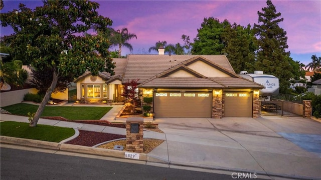 5829 Zapata Pl, Rancho Cucamonga, CA 91737 - view of front of property with a gate, a tile roof, concrete driveway, a chimney, and an attached garage