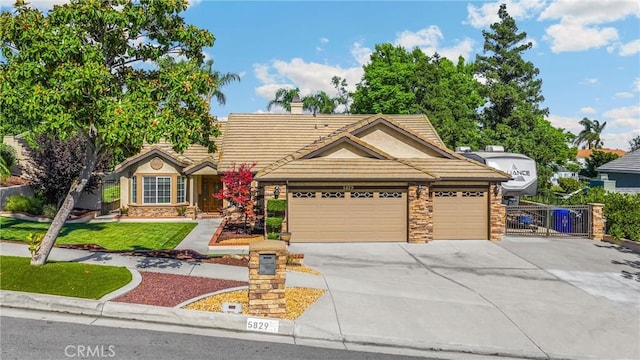 5829 Zapata Pl, Rancho Cucamonga, CA 91737 - view of front of house featuring stone siding, driveway, an attached garage, and a tile roof