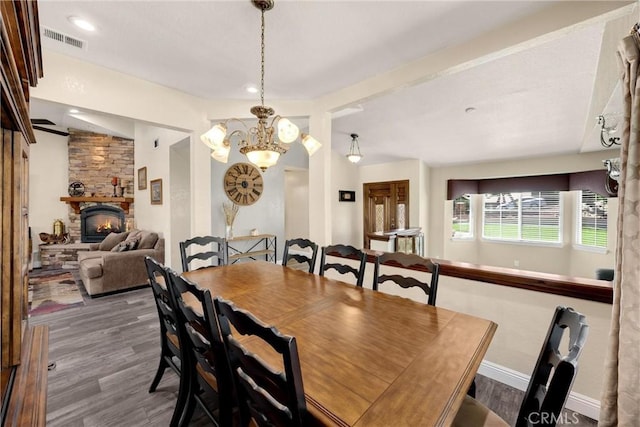 5829 Zapata Pl, Rancho Cucamonga, CA 91737 - dining room with a chandelier, a fireplace, and wood finished floors