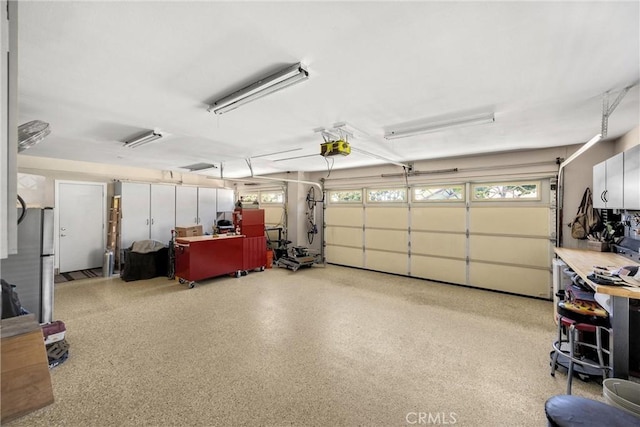 5829 Zapata Pl, Rancho Cucamonga, CA 91737 - garage featuring a garage door opener and freestanding refrigerator