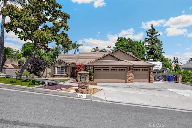 5829 Zapata Pl, Rancho Cucamonga, CA 91737 - view of front of home featuring stone siding, concrete driveway, a tile roof, an attached garage, and a chimney