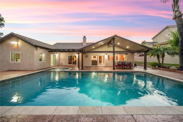 5829 Zapata Pl, Rancho Cucamonga, CA 91737 - pool at dusk with a hot tub, an outdoor pool, and a patio