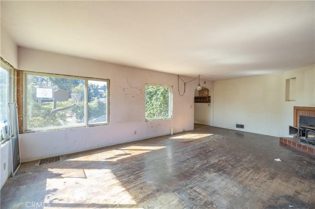 3142 Keith Ave, Castro Valley, CA 94546 - unfurnished living room with a wood stove and wood finished floors