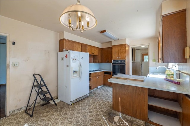 3142 Keith Ave, Castro Valley, CA 94546 - kitchen with white refrigerator with ice dispenser, oven, a peninsula, brown cabinets, and light countertops