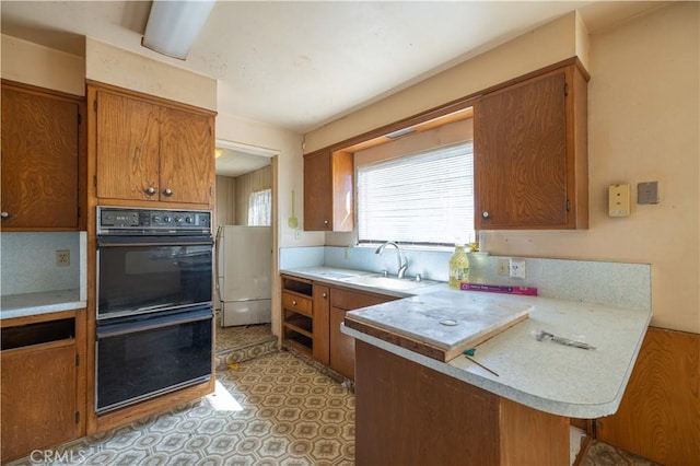 3142 Keith Ave, Castro Valley, CA 94546 - kitchen with brown cabinetry, a peninsula, and light countertops