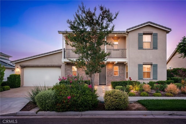 111 Spoke, Irvine, CA 92618 - view of front of house with a balcony, stucco siding, driveway, and an attached garage