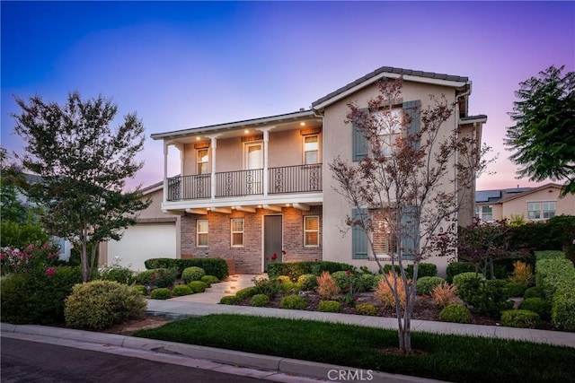 111 Spoke, Irvine, CA 92618 - front facade with a balcony, stucco siding, and an attached garage