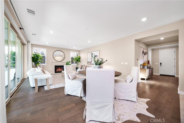 111 Spoke, Irvine, CA 92618 - dining area with dark wood-style flooring, a glass covered fireplace, and recessed lighting