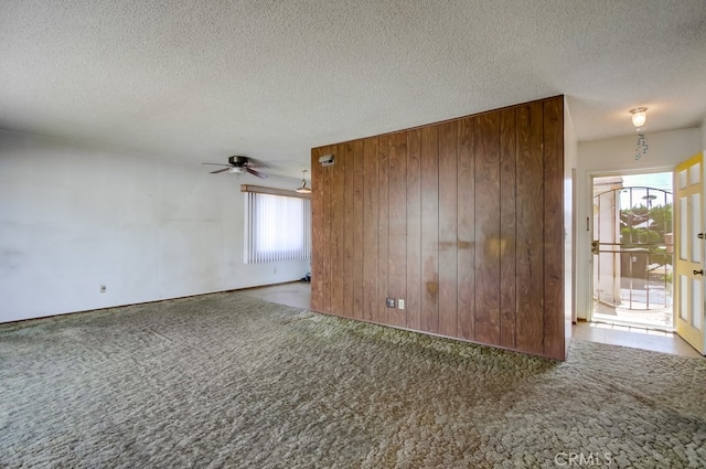 1361 Monterey Ct, Chula Vista, CA 91911 - carpeted spare room with wooden walls, a textured ceiling, and a ceiling fan