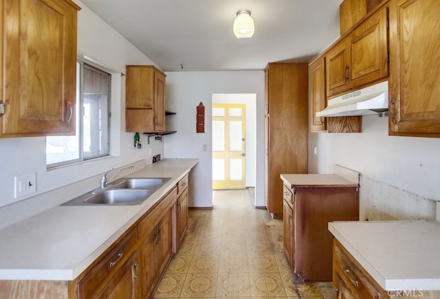 1361 Monterey Ct, Chula Vista, CA 91911 - kitchen featuring under cabinet range hood, brown cabinetry, light countertops, and light flooring
