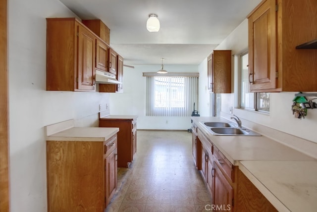 1361 Monterey Ct, Chula Vista, CA 91911 - kitchen featuring brown cabinets, light countertops, under cabinet range hood, and light flooring