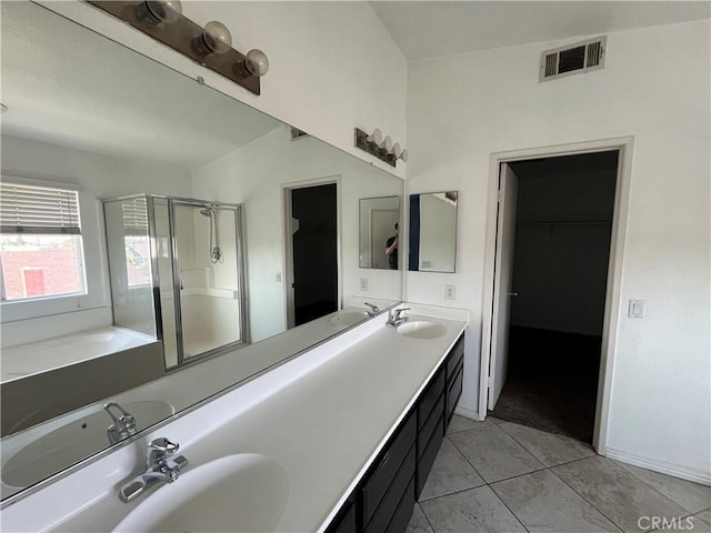 405 E Lurelane St, Rialto, CA 92376 - full bathroom with a shower stall, double vanity, a walk in closet, tile patterned floors, and a garden tub