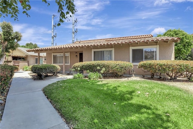 26441 Paseo Carmel Unit 8E, San Juan Capistrano, CA 92675 - view of front facade featuring a tiled roof, stucco siding, and a front lawn