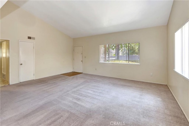 26441 Paseo Carmel Unit 8E, San Juan Capistrano, CA 92675 - empty room featuring light carpet and vaulted ceiling
