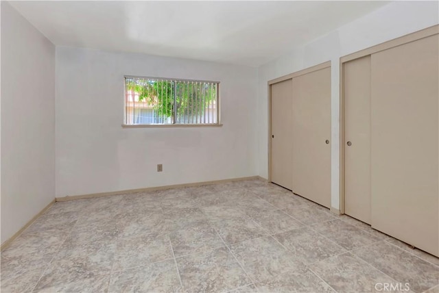 26441 Paseo Carmel Unit 8E, San Juan Capistrano, CA 92675 - unfurnished bedroom with two closets and baseboards