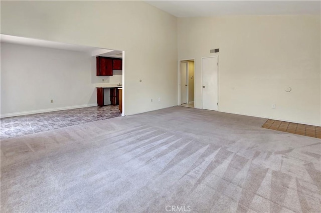 26441 Paseo Carmel Unit 8E, San Juan Capistrano, CA 92675 - empty room featuring light colored carpet and high vaulted ceiling
