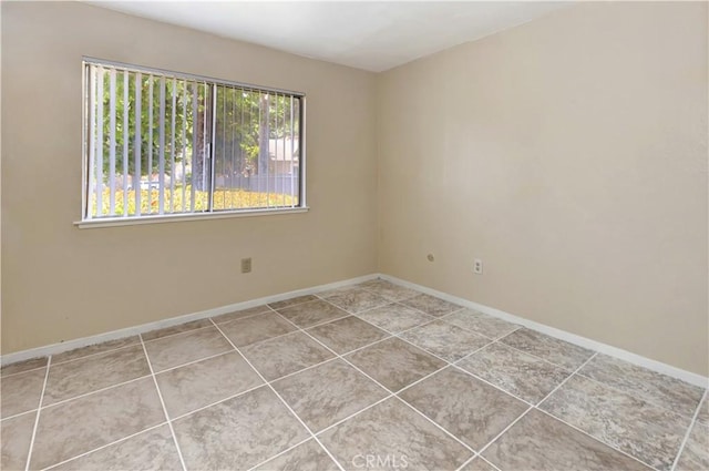 26441 Paseo Carmel Unit 8E, San Juan Capistrano, CA 92675 - tiled spare room featuring baseboards
