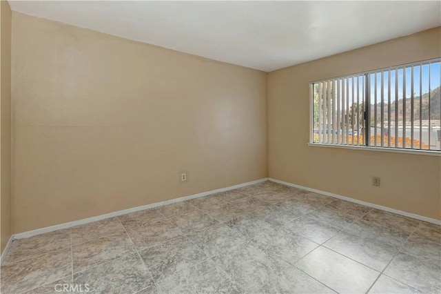 26441 Paseo Carmel Unit 8E, San Juan Capistrano, CA 92675 - tiled spare room featuring baseboards