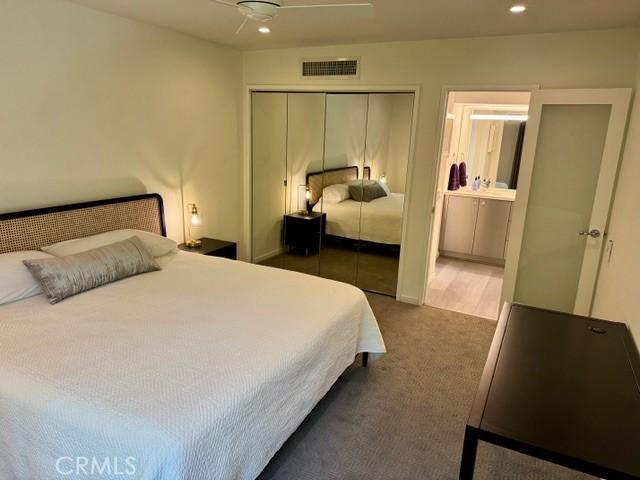 1655 E Palm Canyon Dr Unit 308, Palm Springs, CA 92264 - bedroom with dark carpet, a closet, recessed lighting, ensuite bath, and ceiling fan
