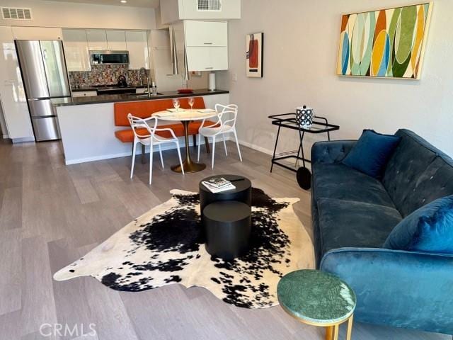 1655 E Palm Canyon Dr Unit 308, Palm Springs, CA 92264 - living area featuring wood finished floors and baseboards