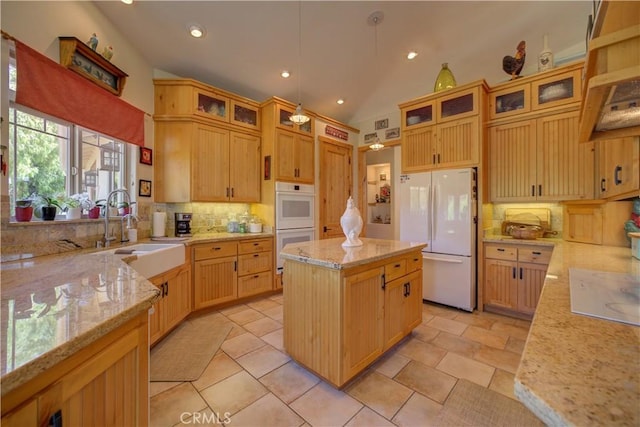 670 Highland Hills Rd, Nipomo, CA 93444 - kitchen with white appliances, backsplash, vaulted ceiling, a kitchen island, and light stone countertops