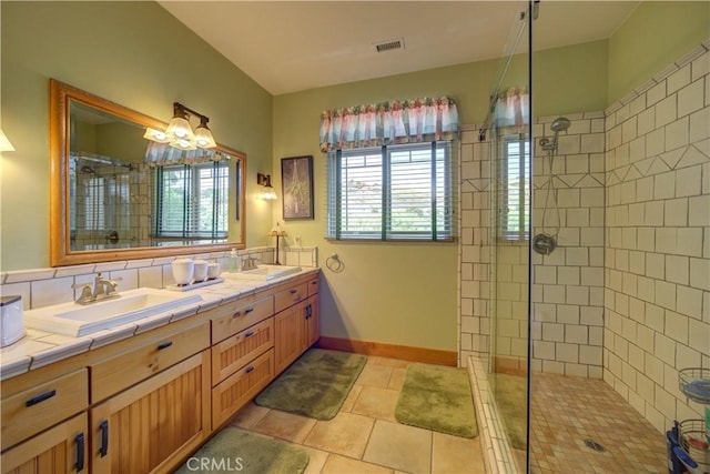 670 Highland Hills Rd, Nipomo, CA 93444 - bathroom with tiled shower, double vanity, a chandelier, and tile patterned flooring