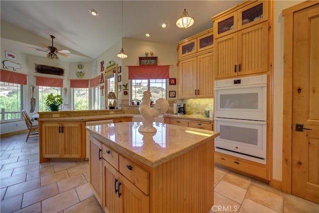 670 Highland Hills Rd, Nipomo, CA 93444 - kitchen featuring double oven, a peninsula, a kitchen island, tasteful backsplash, and lofted ceiling