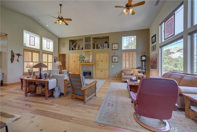670 Highland Hills Rd, Nipomo, CA 93444 - living room with a ceiling fan, high vaulted ceiling, light wood-style floors, and a glass covered fireplace