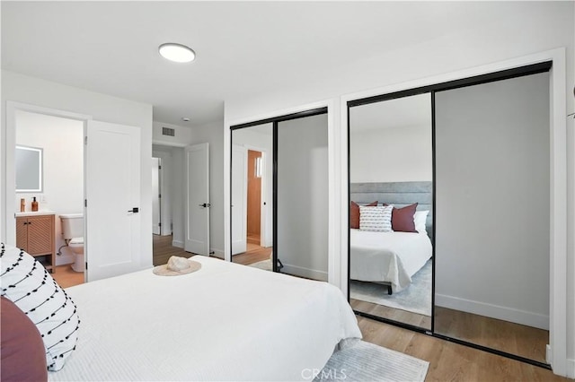 1825 W Carlton Pl, Santa Ana, CA 92704 - bedroom with two closets, light wood finished floors, and ensuite bathroom