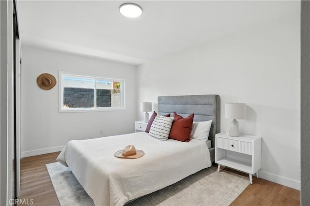 1825 W Carlton Pl, Santa Ana, CA 92704 - bedroom with baseboards and wood finished floors