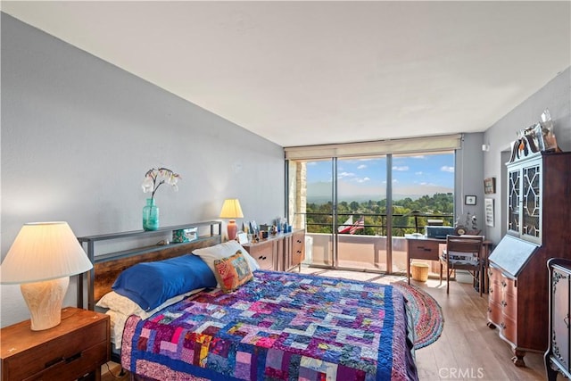 24055 W Paseo Del Lago Unit 962, Laguna Woods, CA 92637 - bedroom featuring access to outside, wood finished floors, a wall of windows, and a desk
