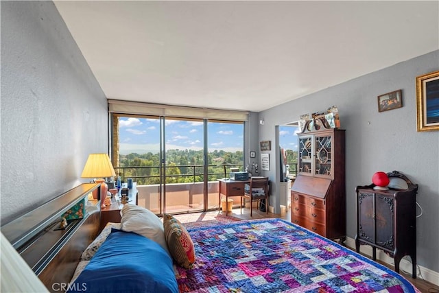 24055 W Paseo Del Lago Unit 962, Laguna Woods, CA 92637 - bedroom featuring a textured wall, access to outside, a wall of windows, and wood finished floors