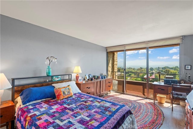 24055 W Paseo Del Lago Unit 962, Laguna Woods, CA 92637 - bedroom with access to exterior, a wall of windows, and wood finished floors