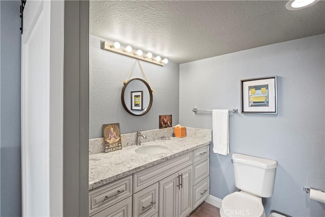 24055 W Paseo Del Lago Unit 962, Laguna Woods, CA 92637 - bathroom featuring vanity, a textured ceiling, and wood finished floors