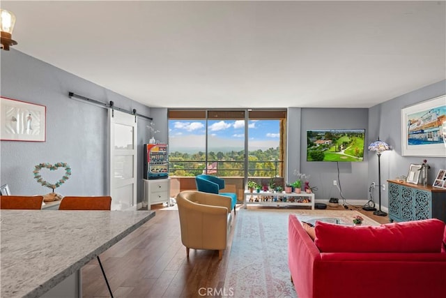 24055 W Paseo Del Lago Unit 962, Laguna Woods, CA 92637 - living room with a barn door, wood finished floors, and a wall of windows