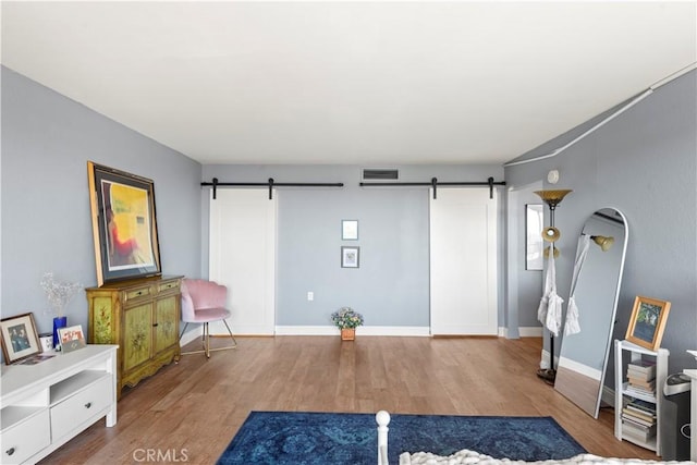 24055 W Paseo Del Lago Unit 962, Laguna Woods, CA 92637 - unfurnished room featuring a barn door and wood finished floors