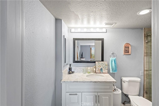 24055 W Paseo Del Lago Unit 962, Laguna Woods, CA 92637 - bathroom featuring a textured wall, vanity, a textured ceiling, and a shower with door