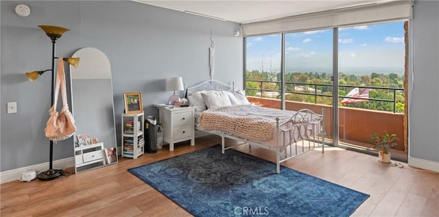 24055 W Paseo Del Lago Unit 962, Laguna Woods, CA 92637 - bedroom with multiple windows, wood finished floors, access to outside, and arched walkways