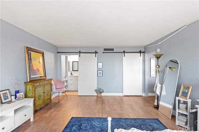 24055 W Paseo Del Lago Unit 962, Laguna Woods, CA 92637 - exercise area featuring a barn door and light wood finished floors