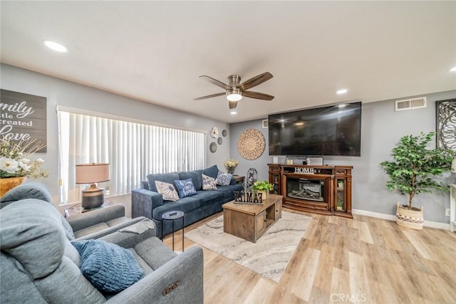 1181 W Westmont Ave, Hemet, CA 92543 - living room featuring a ceiling fan, wood finished floors, recessed lighting, and a glass covered fireplace