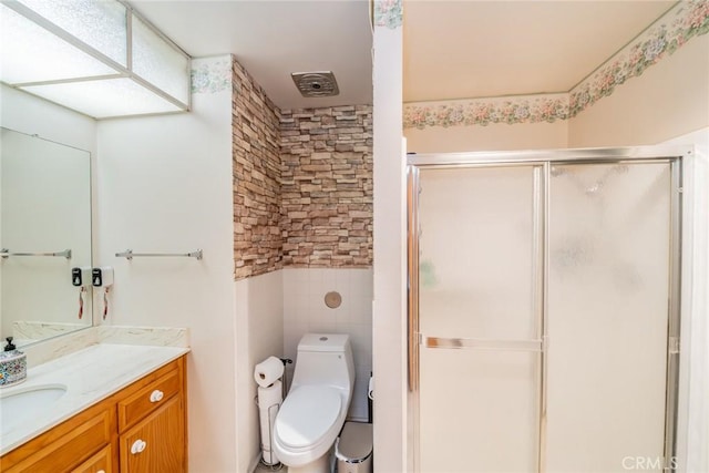 1181 W Westmont Ave, Hemet, CA 92543 - bathroom featuring vanity, a stall shower, and tile walls
