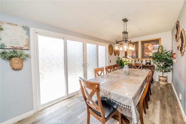 1181 W Westmont Ave, Hemet, CA 92543 - dining room featuring light wood-style flooring and a chandelier