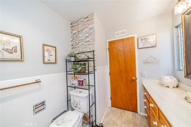 1181 W Westmont Ave, Hemet, CA 92543 - bathroom with vanity, wainscoting, and tile walls
